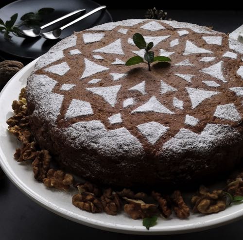 Chocolate cake with powdered sugar stenciled onto it