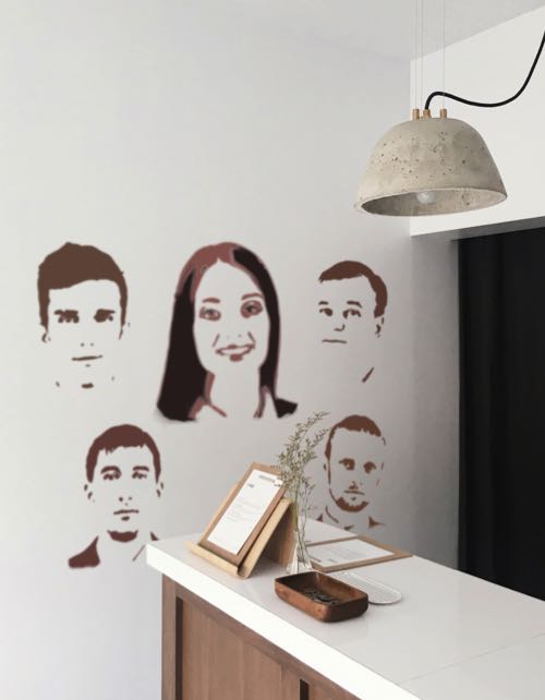 Employee faces stenciled onto lobby wall